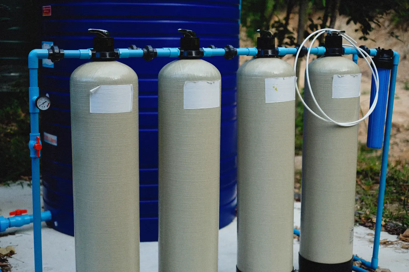 Water treatment equipment connected by bright blue pipes.