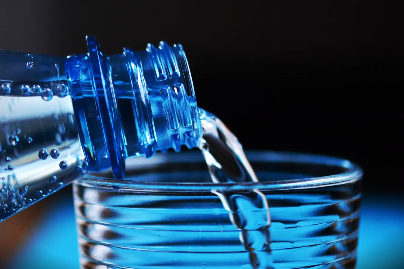 Clear water flowing from a household tap.