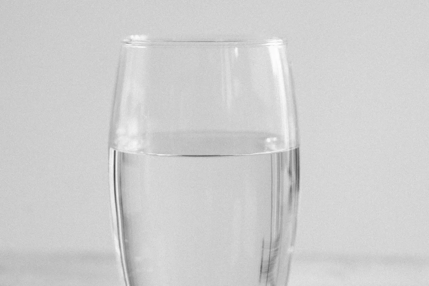 A clear glass filled with drinking water.
